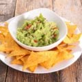 guacamole recipe with chips on plate on top of table