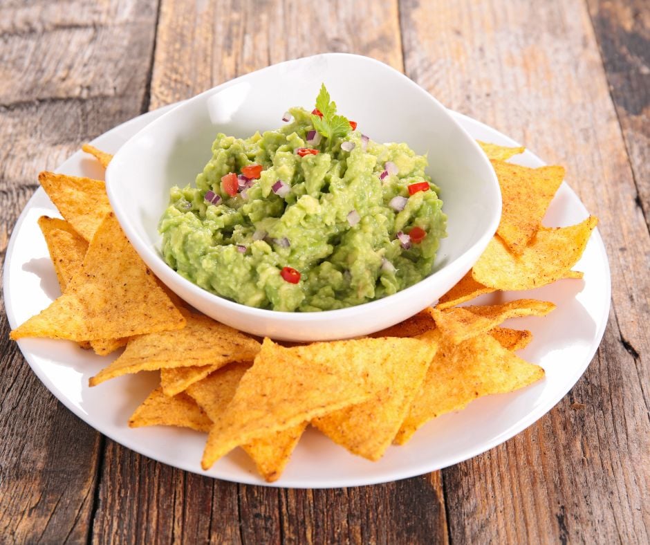 guacamole recipe with chips on plate on top of table