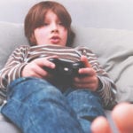 child playing video games while Stay Home Alone