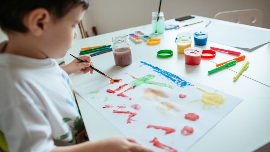Child painting a picture. 3 Ways to saving kids artwork