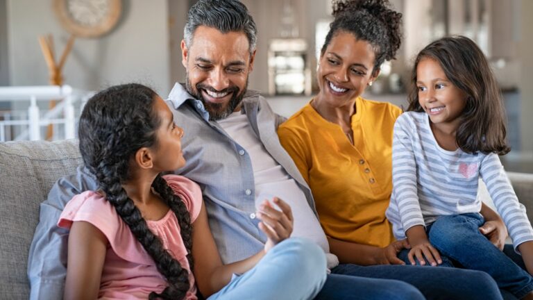 mom dad and daughters on couch