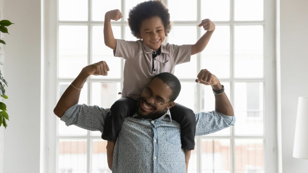 dad and son with son on dads shoulders