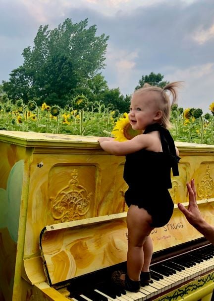 girl on a piano in Sunflower Fields