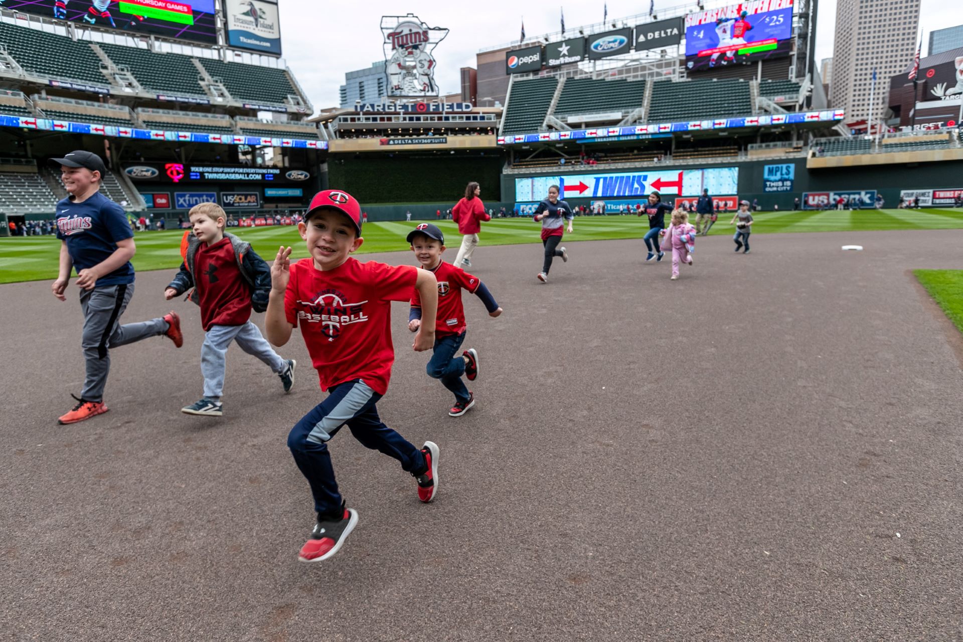 kids running bases at target field in minneapolis part of kids sunday game day