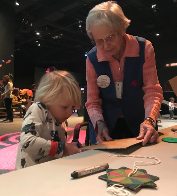 child and adult at the science museum of Minnesota making an art project