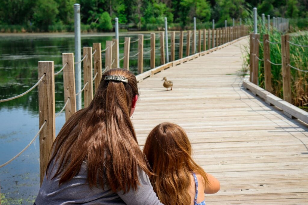 mom and daughter looking at duck at wood lake nature center. Richfield with Kids