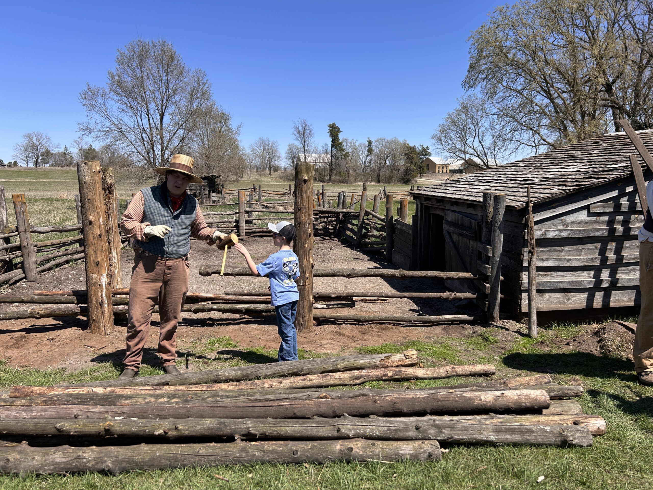 boy and farmer building a fence on the farm in elk river