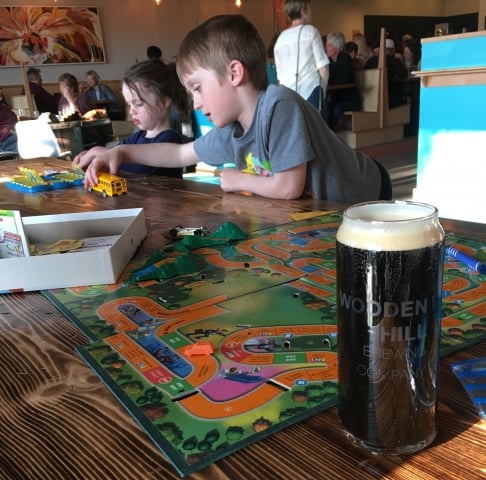 Wooden Hill is part of our kid friendly breweries series. Boy playing board game