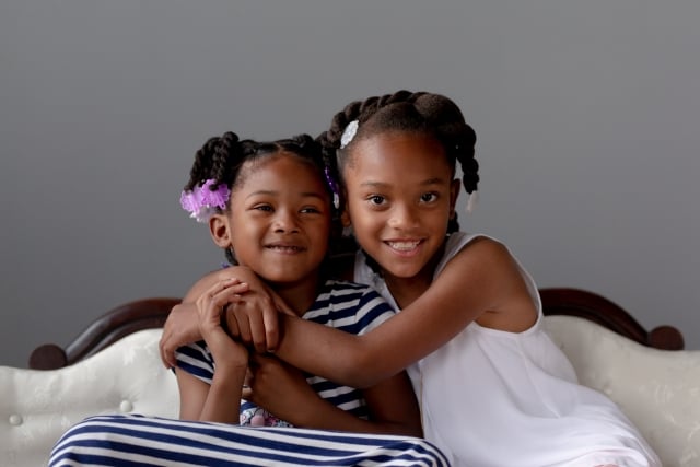 Annika and Alaya Bullock of Brooklyn Park hang out during a recent family photo shoot. Photo courtesy of Traci Buse/Blue Roots Photography